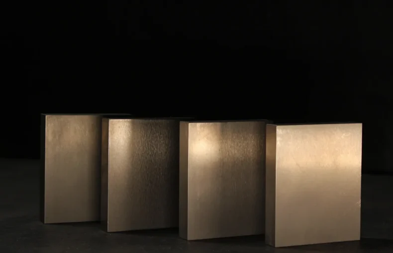 Four tungsten bucking bars of graduated sizes lined up on a dark bench, the general-purpose and shaped bars a kit aircraft build needs